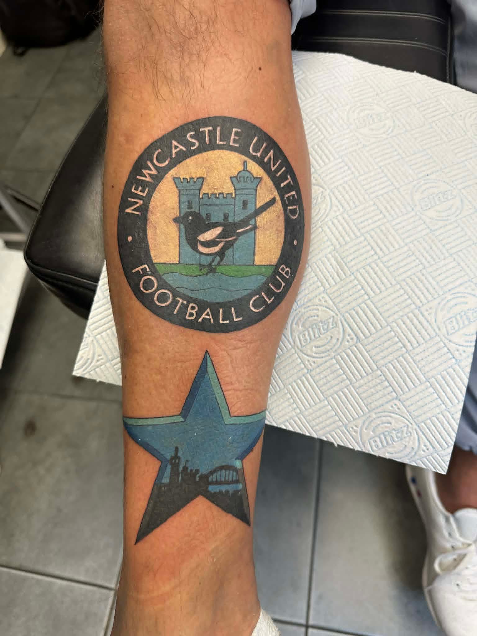 Newcastle United Football Club retro badge with magpie and Tyne star on shin by John Quinn at Tattoo Zone, tattoos Newcastle.