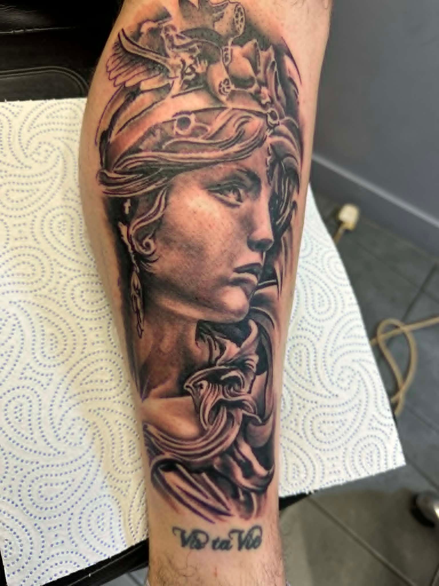 Realism Athena Greek statue with winged helmet calf tattoo by John Quinn at Tattoo Zone Newcastle.