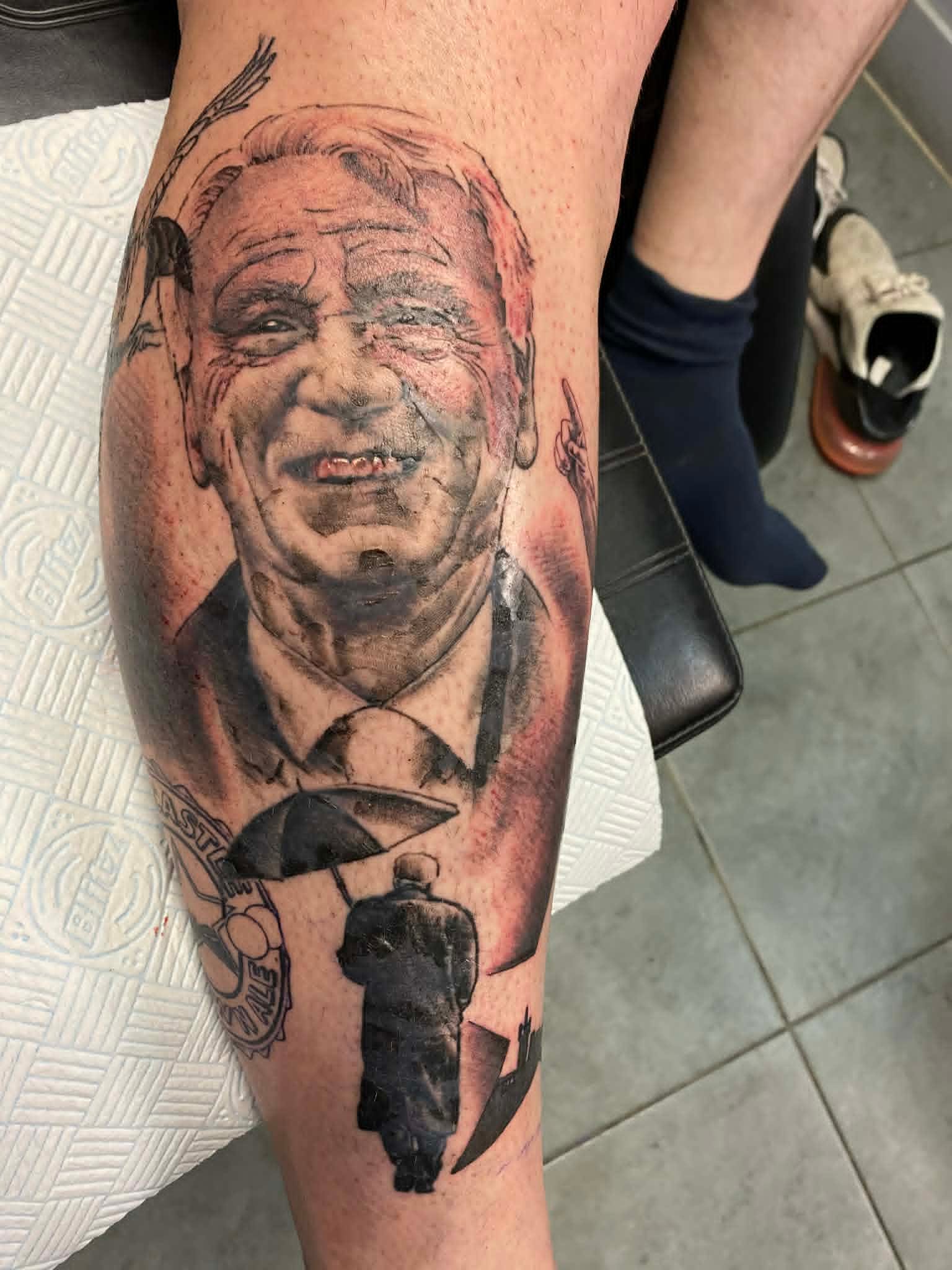 Black and grey realism Bobby Robson Newcastle United portrait calf tattoo by John Quinn at Tattoo Zone, tattoos Newcastle.