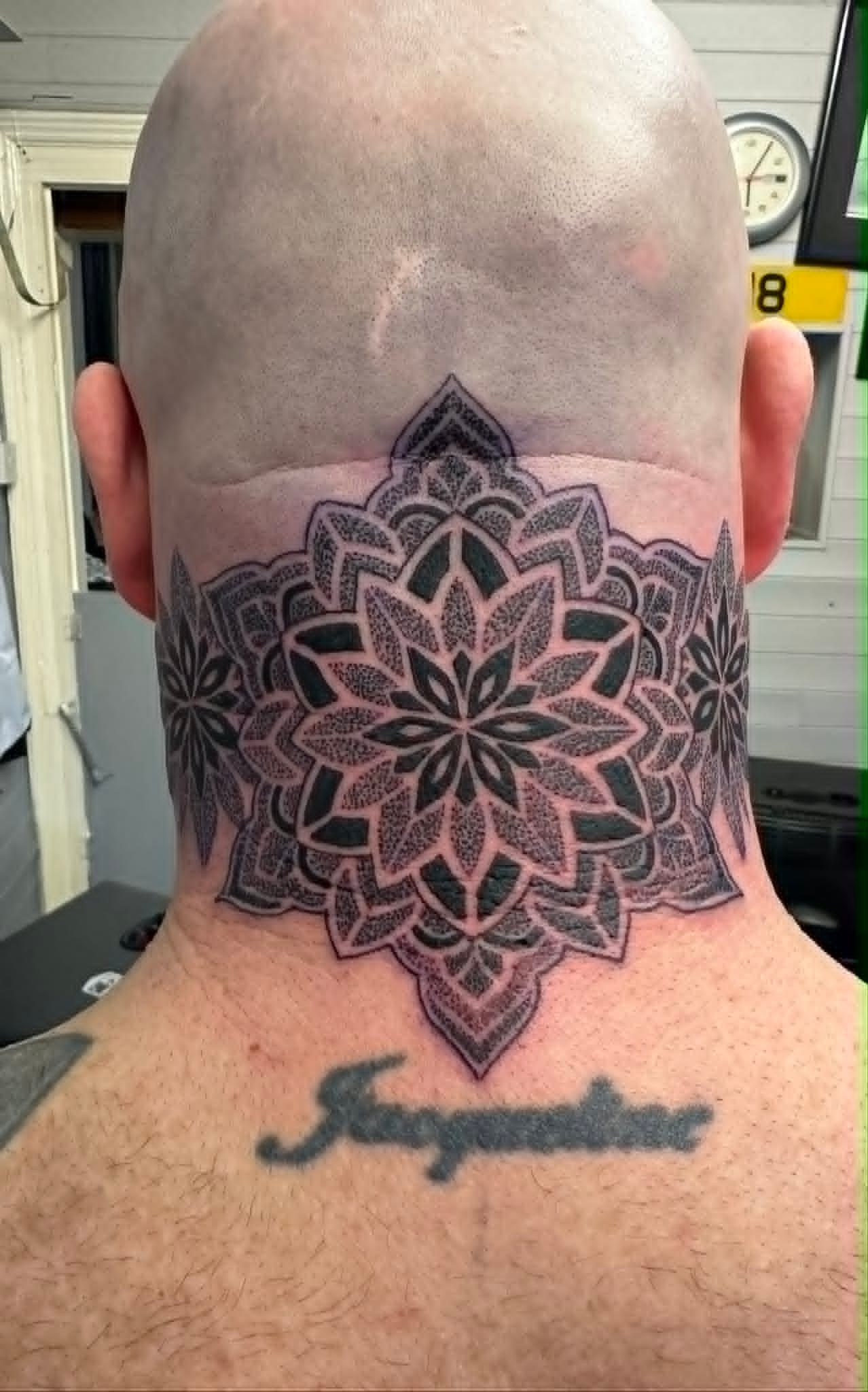 Custom dotwork mandala tattoo on the back of the neck by John Quinn at Tattoo Zone, tattoos Newcastle.