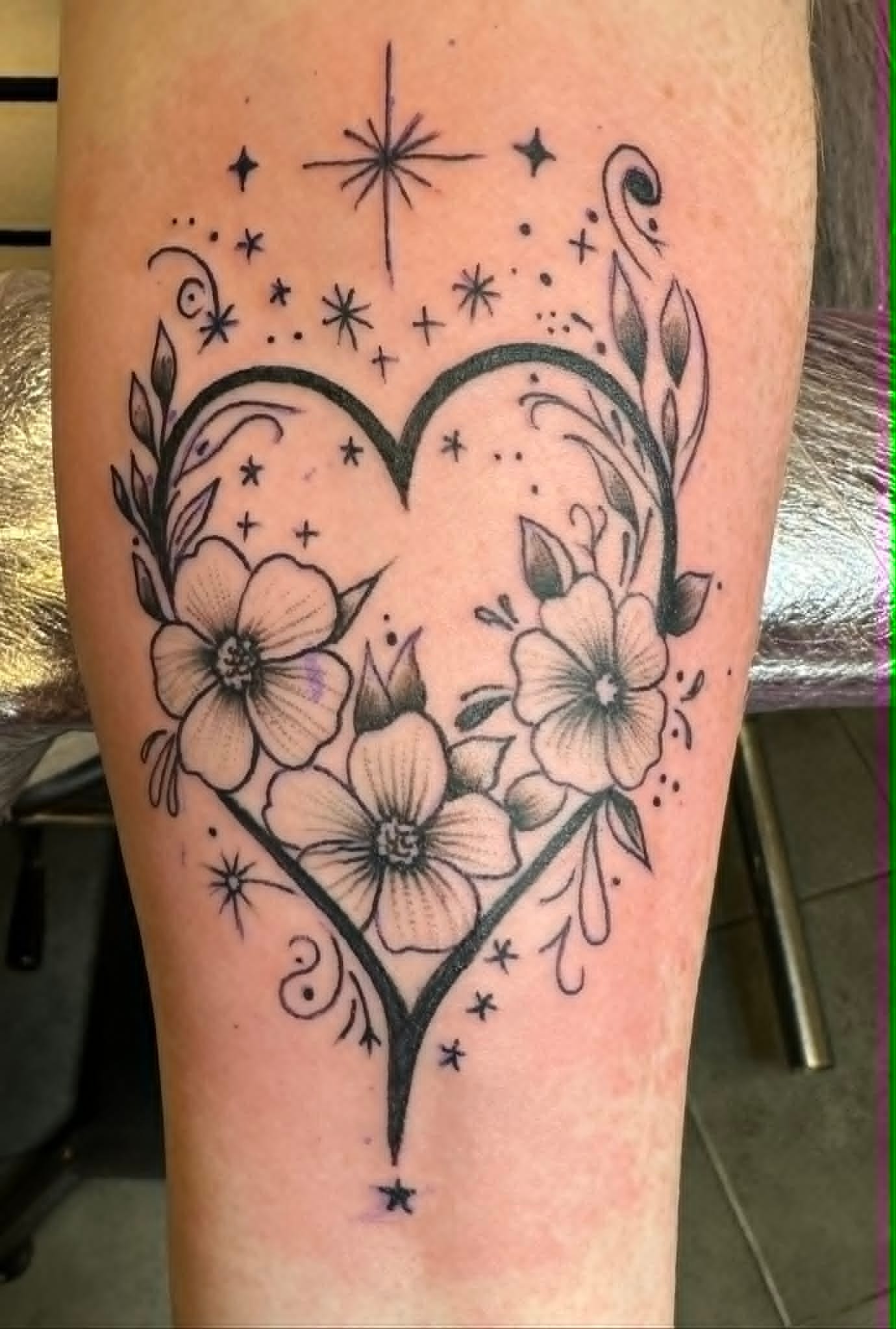 Fine line heart with flowers and stars on the forearm by John Quinn at Tattoo Zone Newcastle.