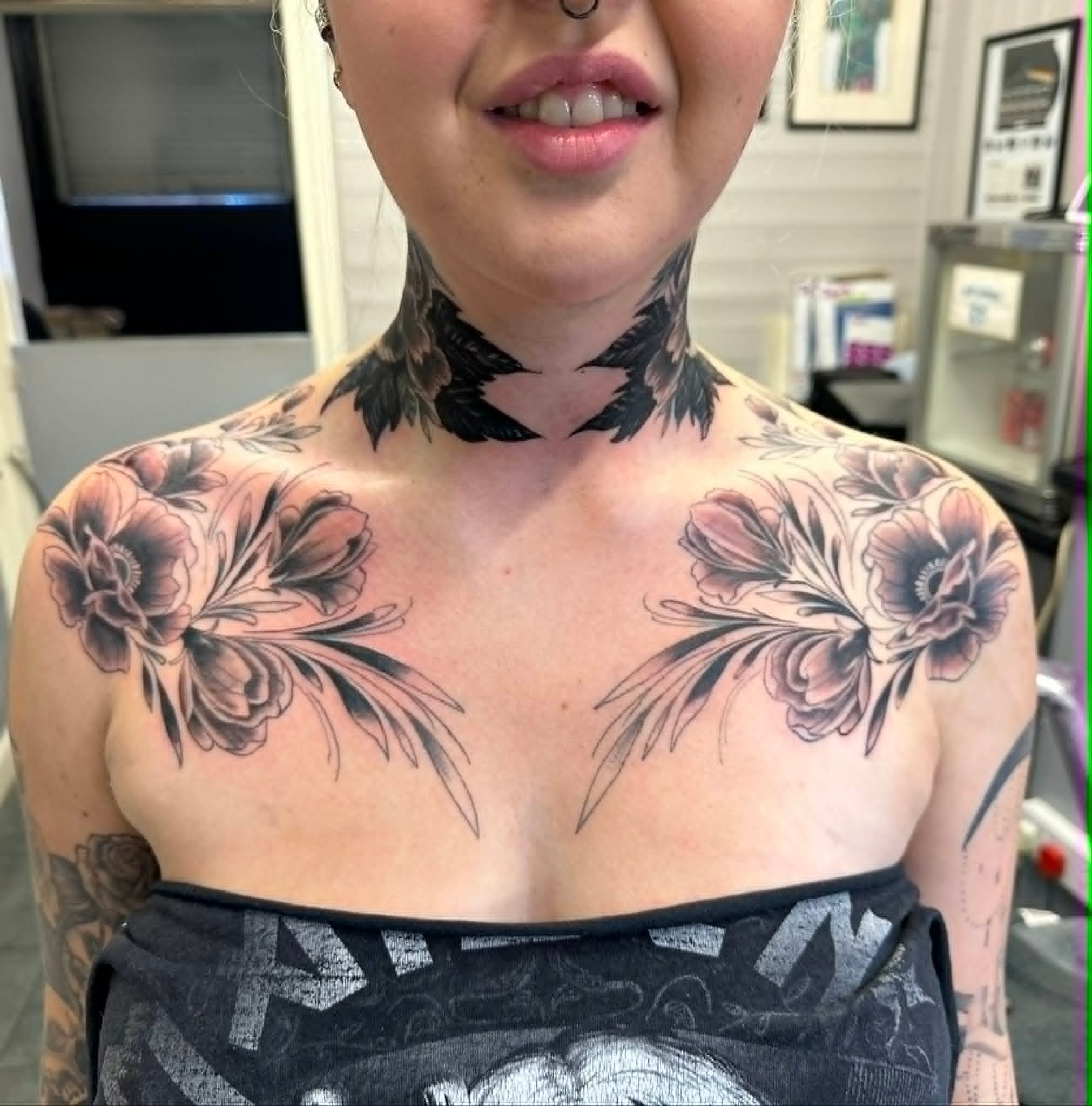Black and grey symmetrical floral chest and neck piece tattoo by John Quinn at Tattoo Zone, tattoos Newcastle.