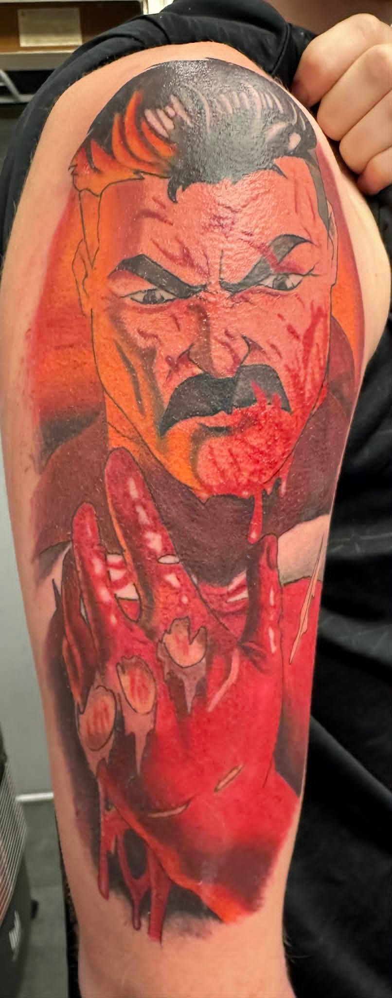 Hellboy colour comic realism upper arm tattoo, colour tattoos Newcastle by John Quinn, Tattoo Zone Byker.