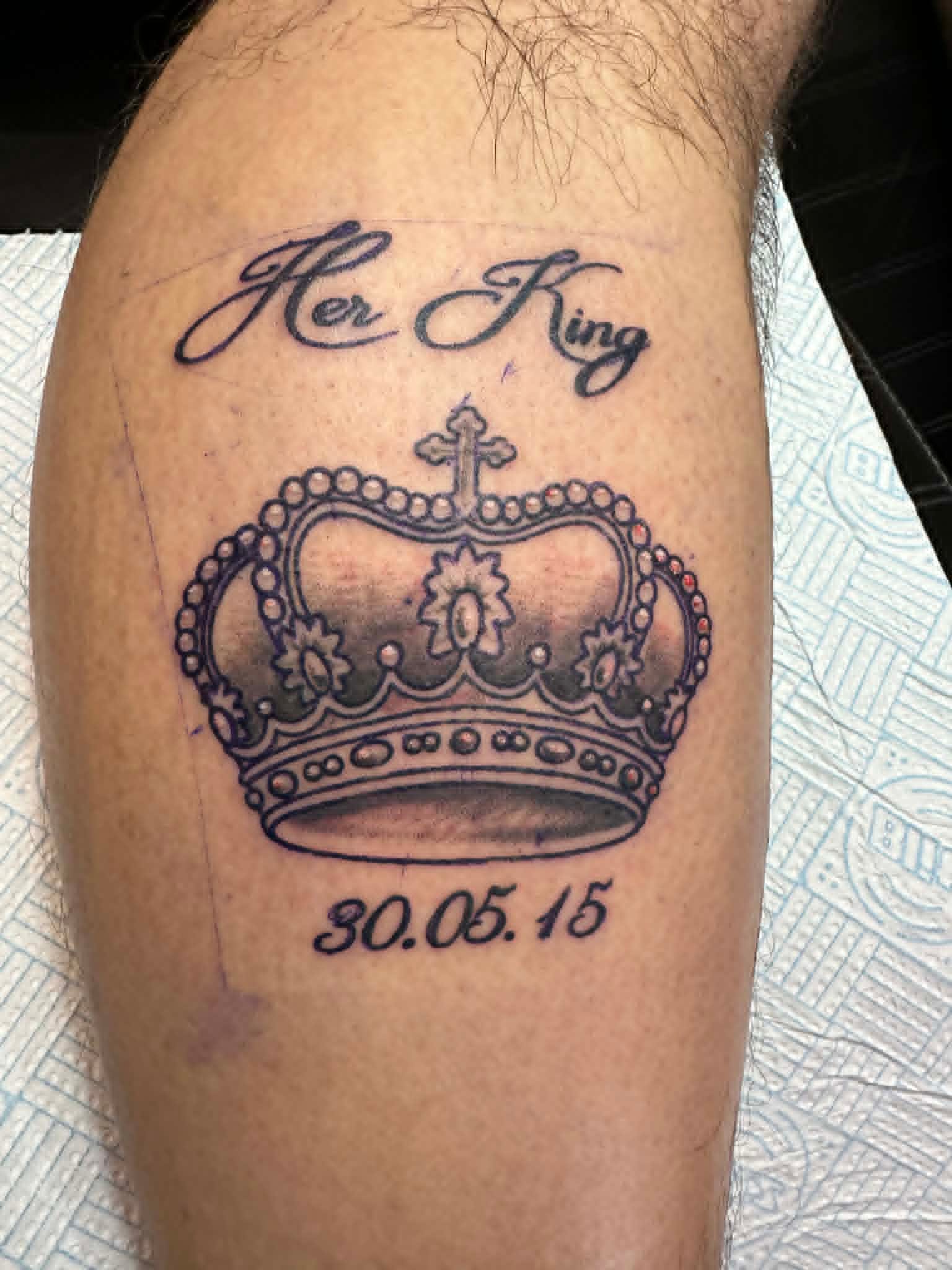Custom Her King script with regal cross topped crown and date calf tattoo by John Quinn at Tattoo Zone Newcastle.
