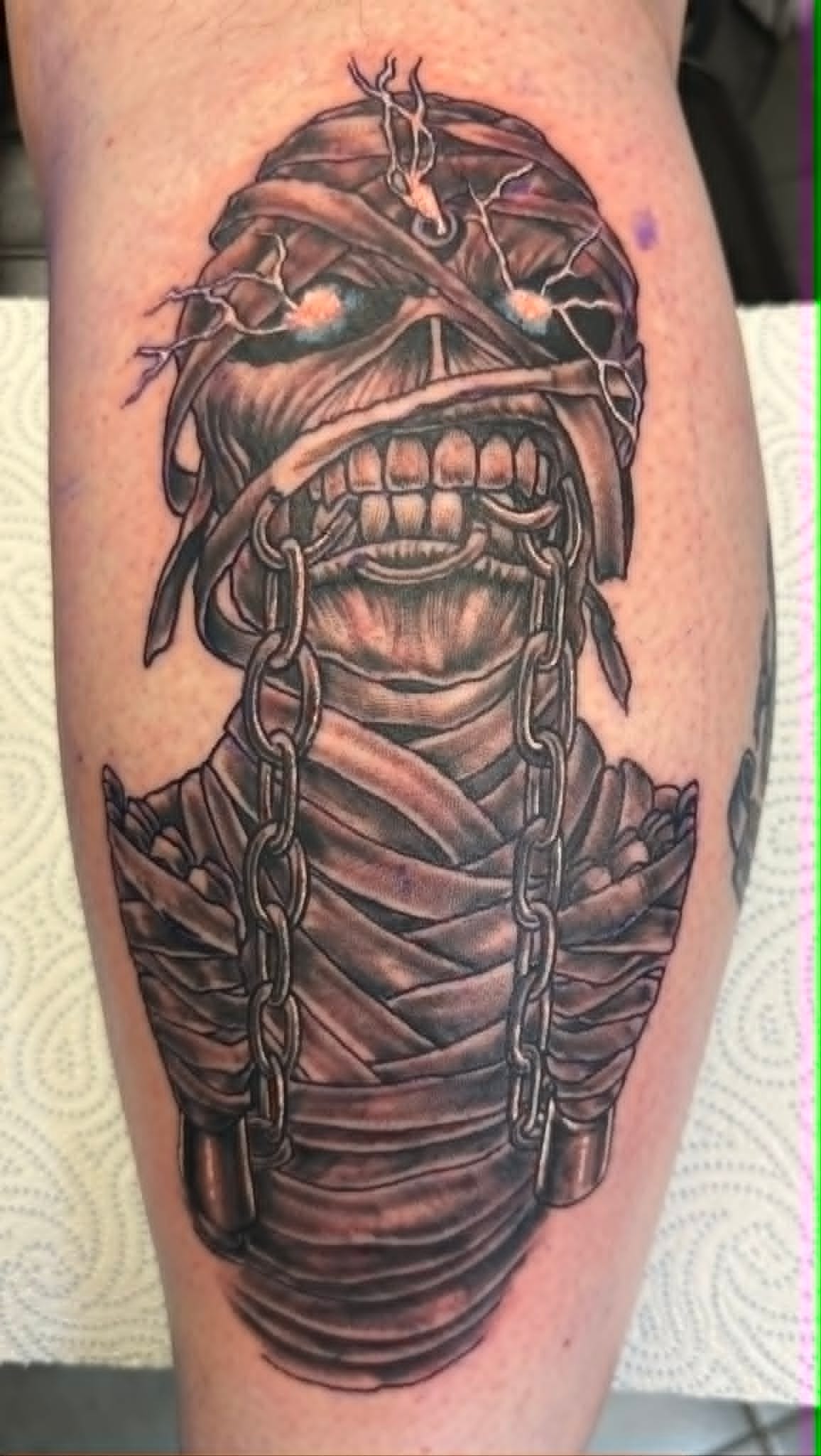 Black and grey Iron Maiden Eddie mummy leg tattoo by John Quinn at Tattoo Zone, tattoos Newcastle.