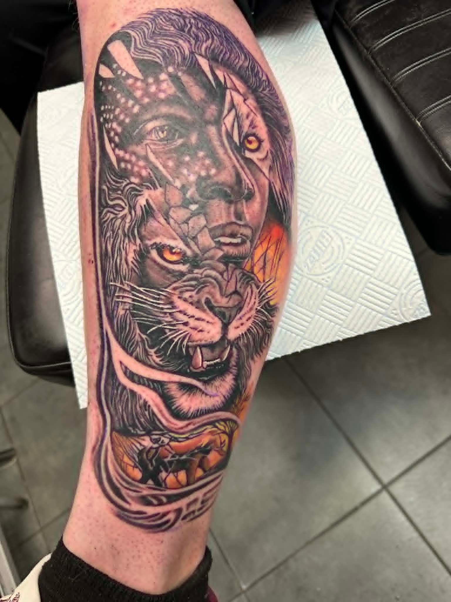 Black and grey realism lion and tiger composite calf tattoo by John Quinn, tattoos Newcastle, Tattoo Zone Byker.