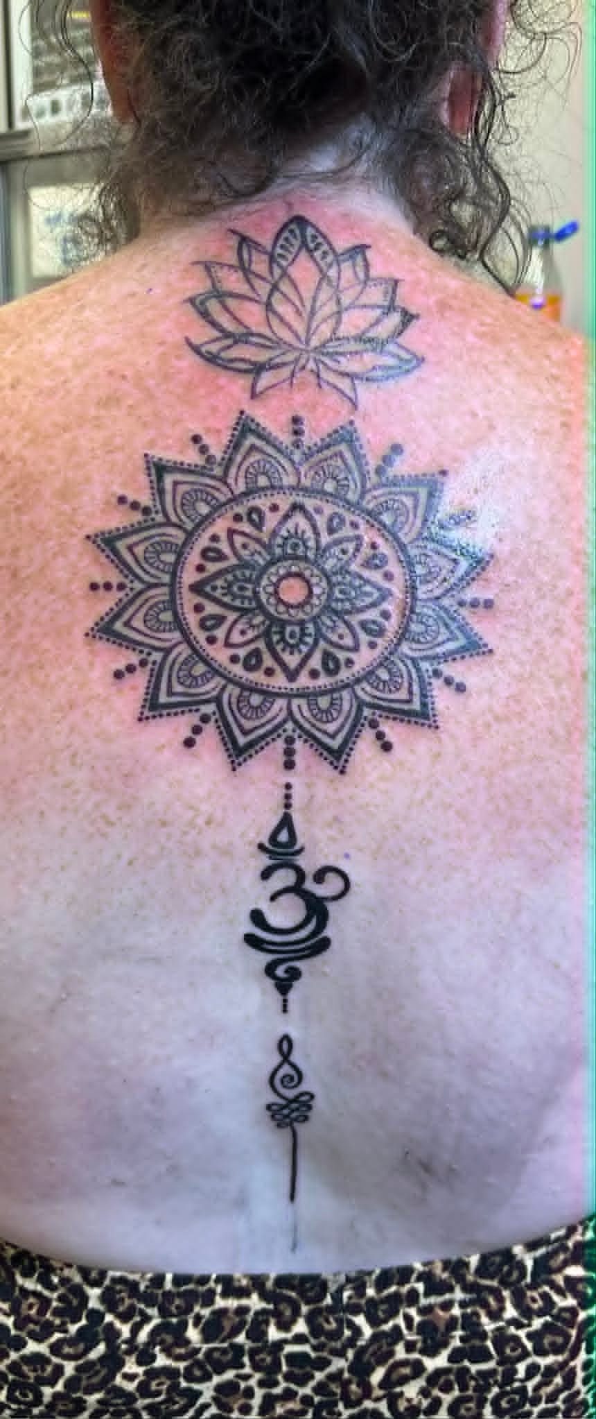 Black and grey lotus mandala and Om spine tattoo by John Quinn at Tattoo Zone, tattoos Newcastle.
