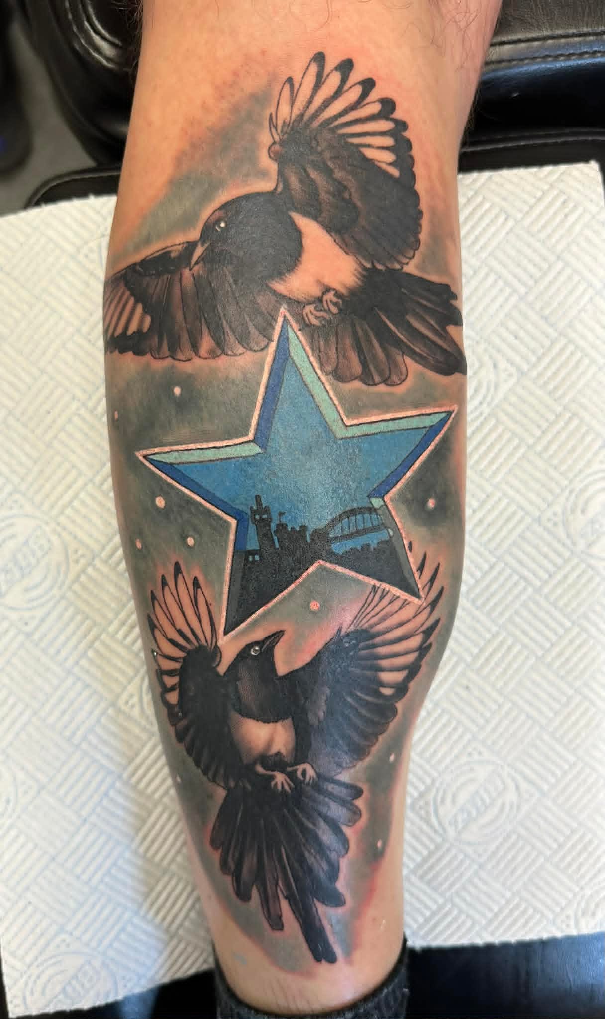 Magpies and Tyne Bridge skyline framed in NUFC star on calf by John Quinn at Tattoo Zone, tattoos Newcastle.