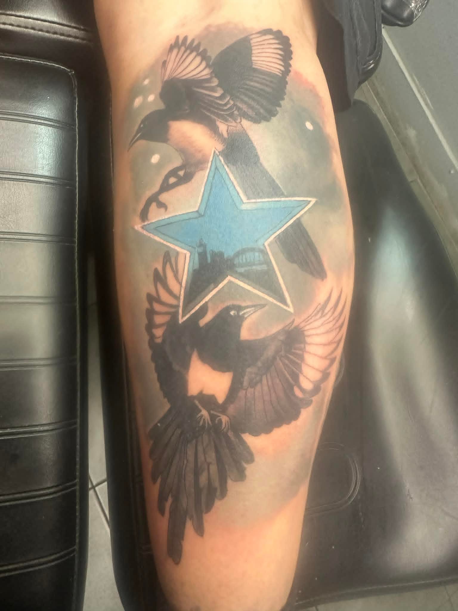 Two magpies framing a Tyne Bridge star on calf by John Quinn at Tattoo Zone, tattoos Newcastle.