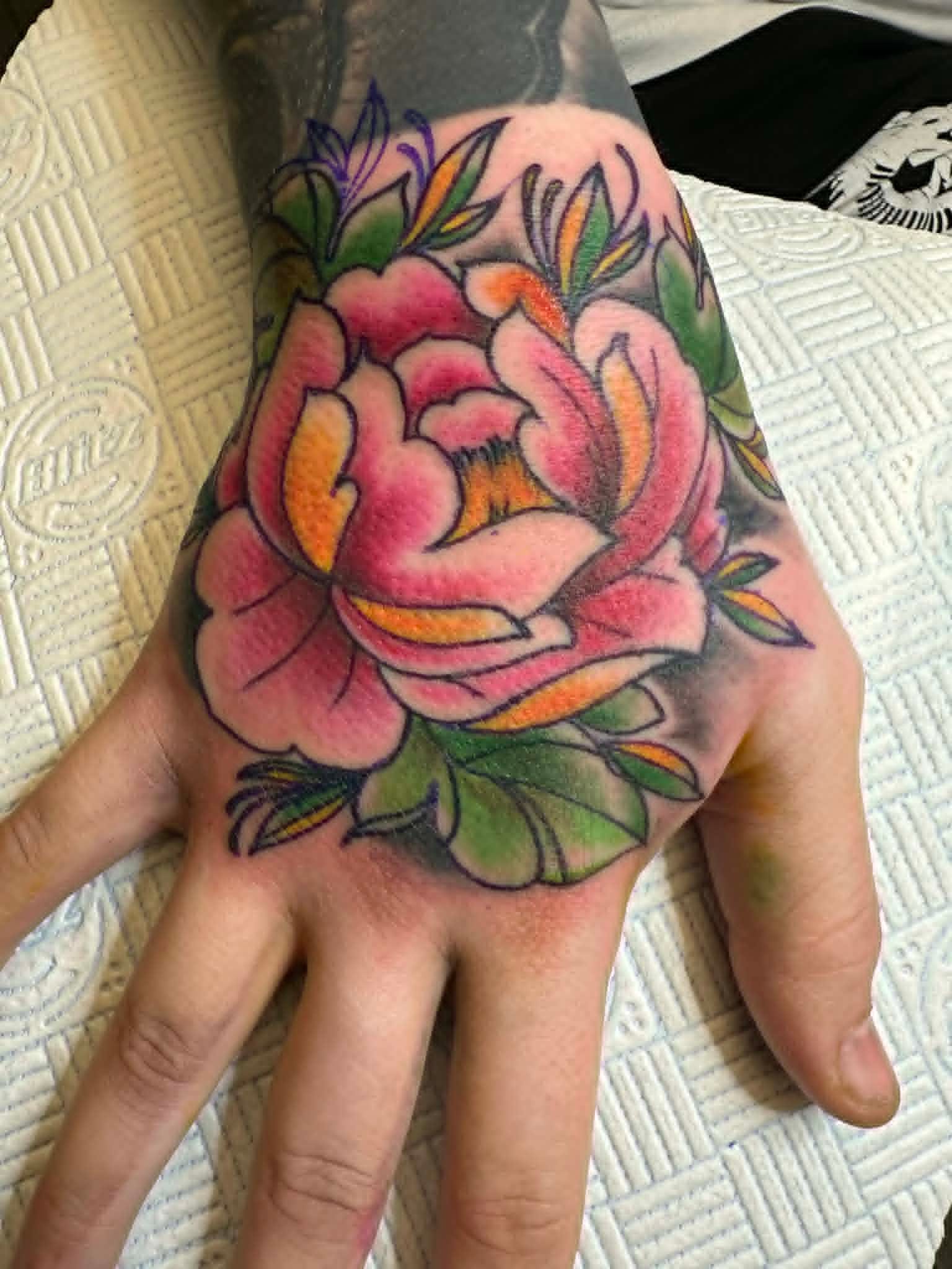 Neo traditional colour peony flower hand tattoo by John Quinn at Tattoo Zone, tattoos Newcastle.