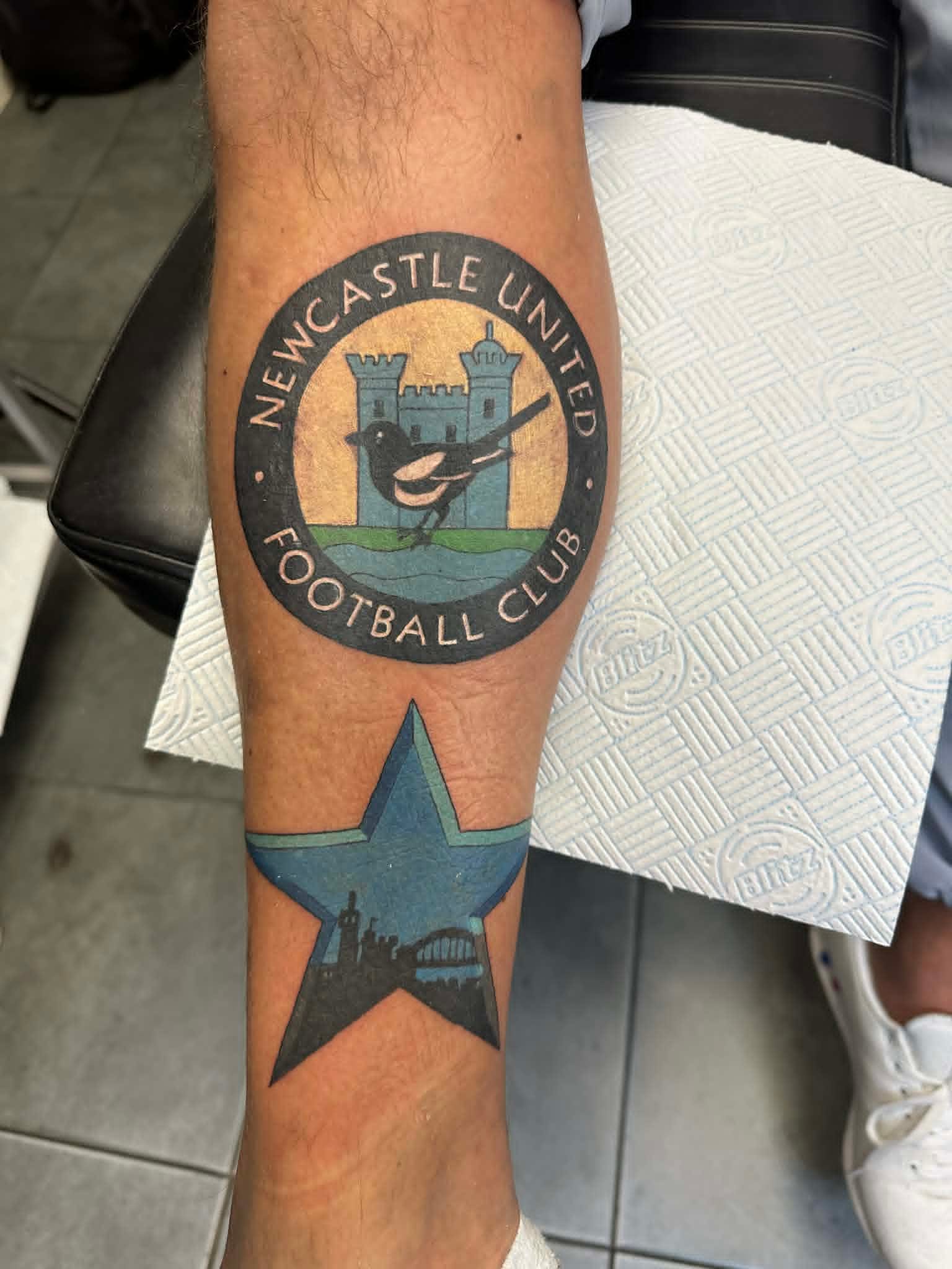 Newcastle United Football Club retro badge with magpie and Tyne star on shin by John Quinn at Tattoo Zone, tattoos Newcastle.