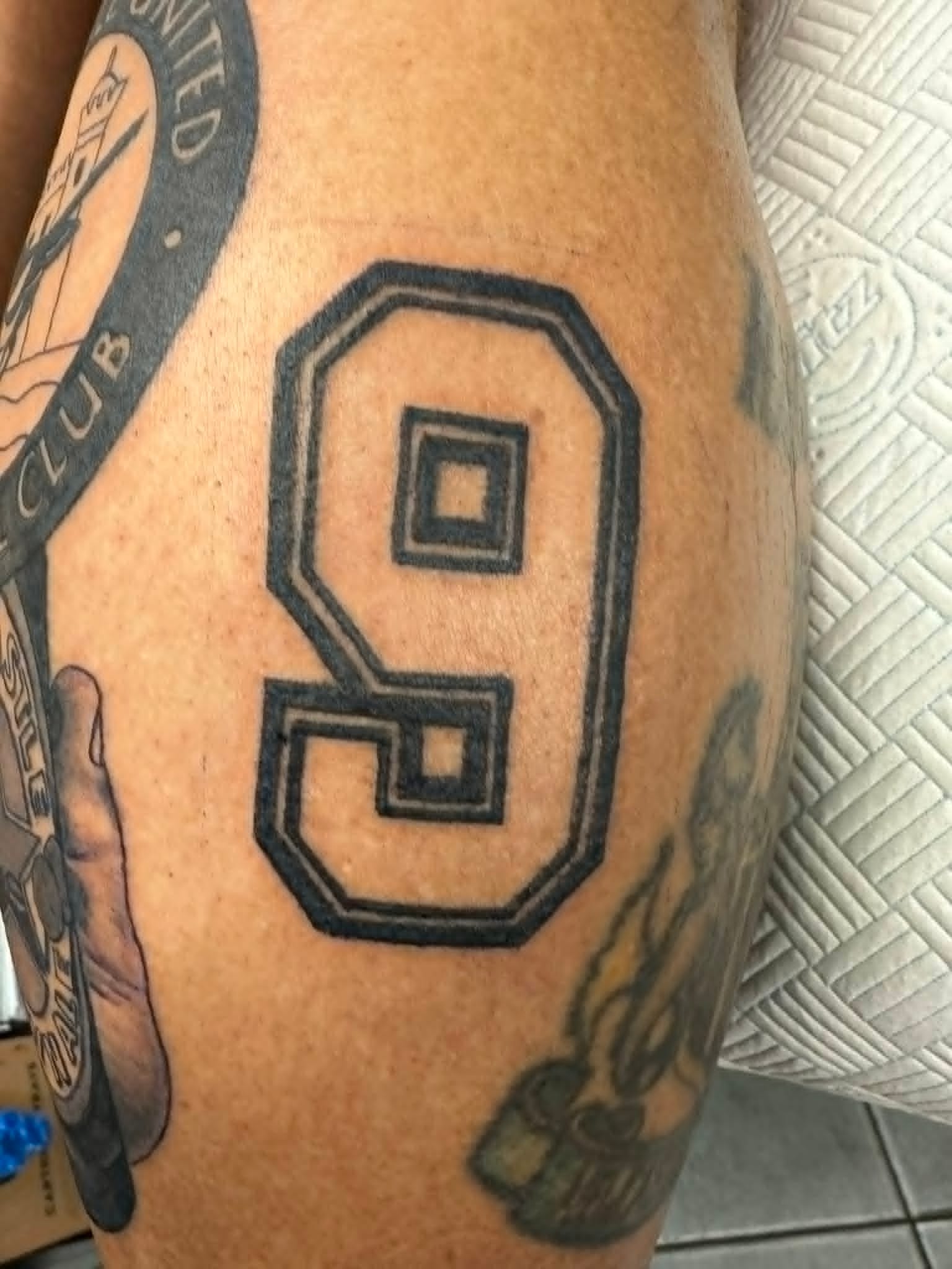 Newcastle United number nine shirt thigh tattoo by John Quinn at Tattoo Zone, tattoos Newcastle.