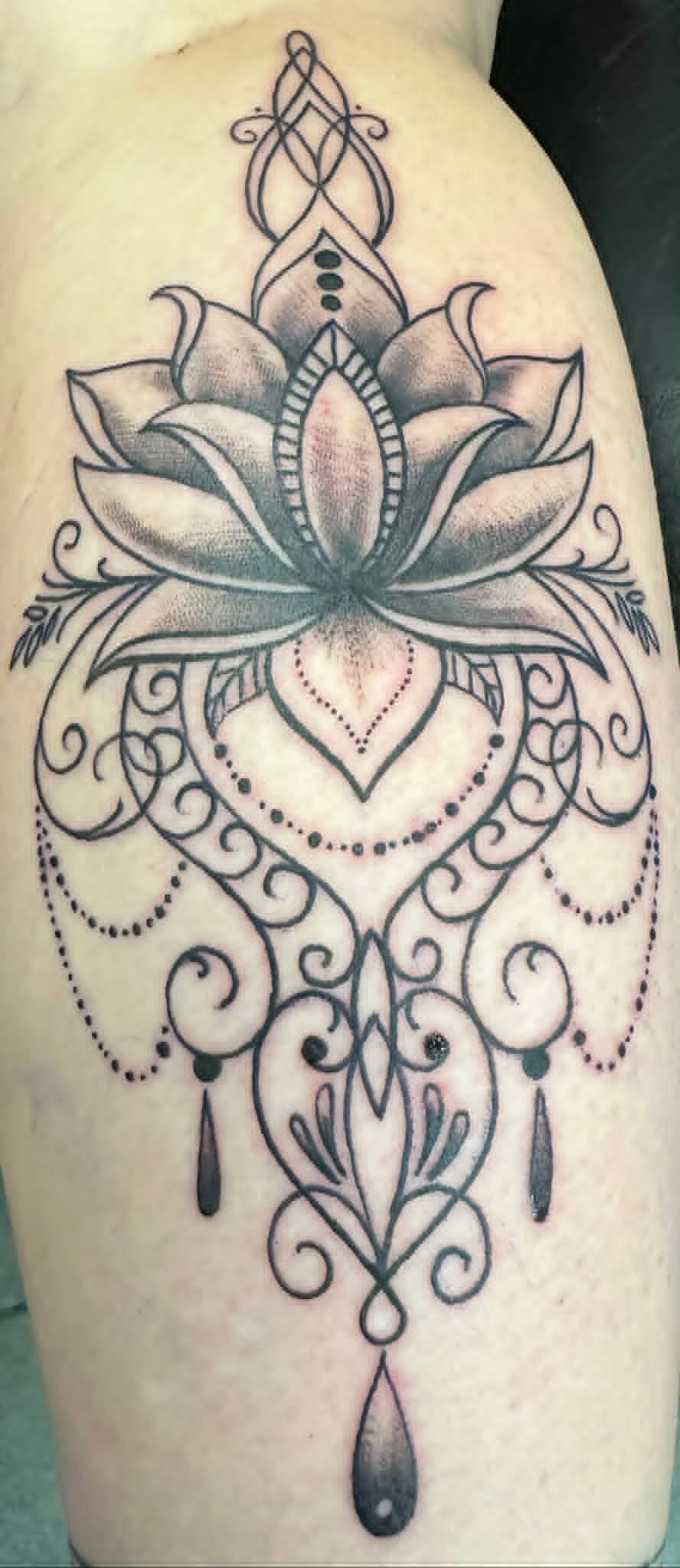 Fine line ornamental lotus and chandelier thigh tattoo by John Quinn at Tattoo Zone, tattoos Newcastle.