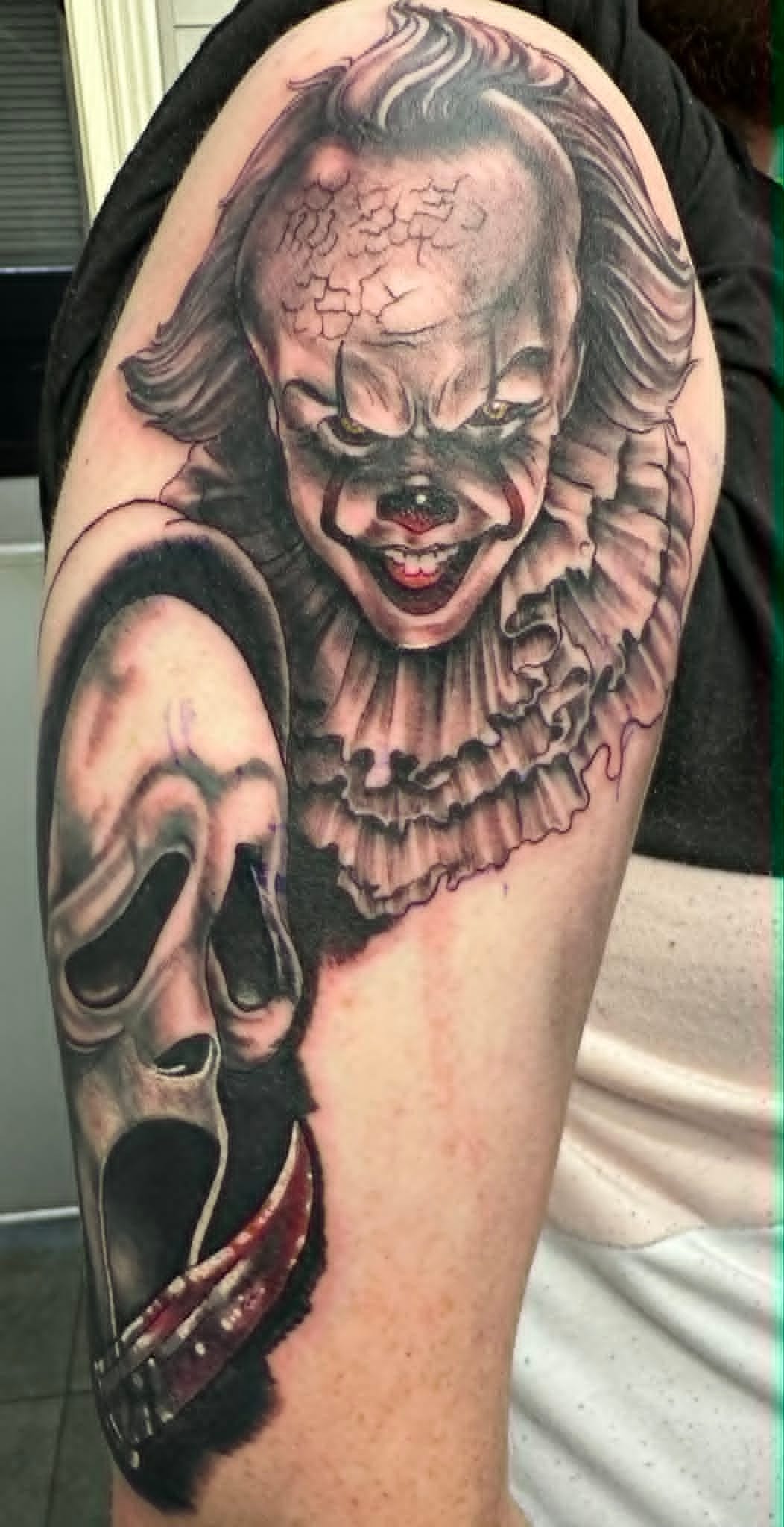 Black and grey realism Pennywise and Ghostface horror arm tattoo by John Quinn at Tattoo Zone, tattoos Newcastle.