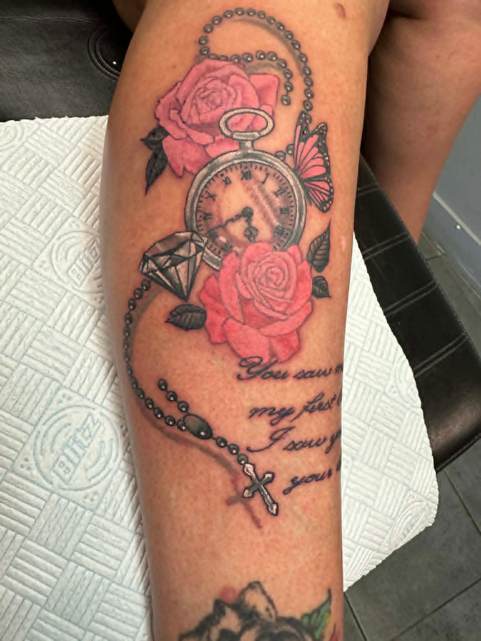 Pocket watch pink roses butterfly and rosary leg tattoo by John Quinn at Tattoo Zone, tattoos Newcastle.