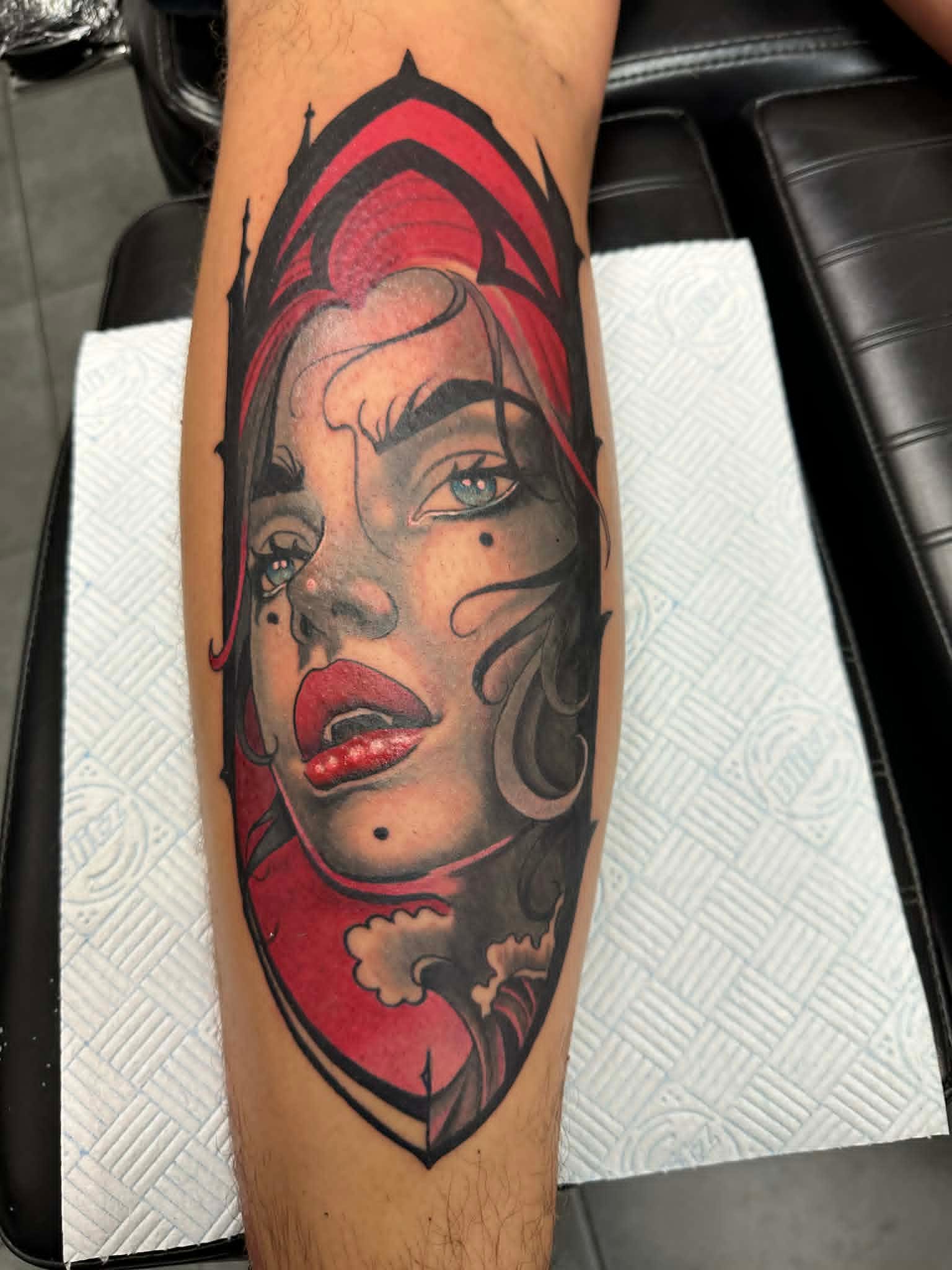 Custom neo traditional red riding hood woman portrait in gothic frame calf tattoo by John Quinn at Tattoo Zone Newcastle.