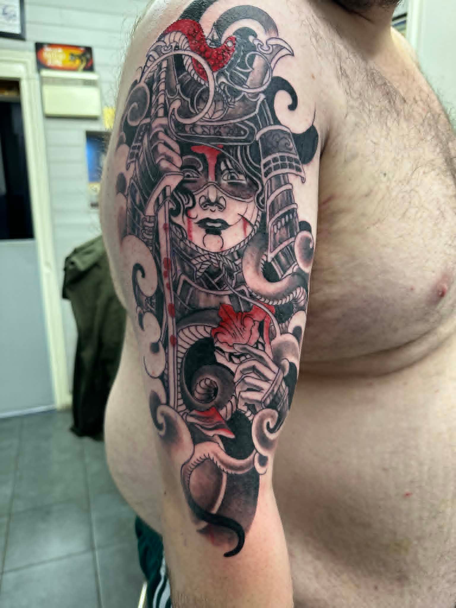 Custom samurai geisha black grey and red sleeve tattoo by John Quinn at Tattoo Zone, tattoos Newcastle.