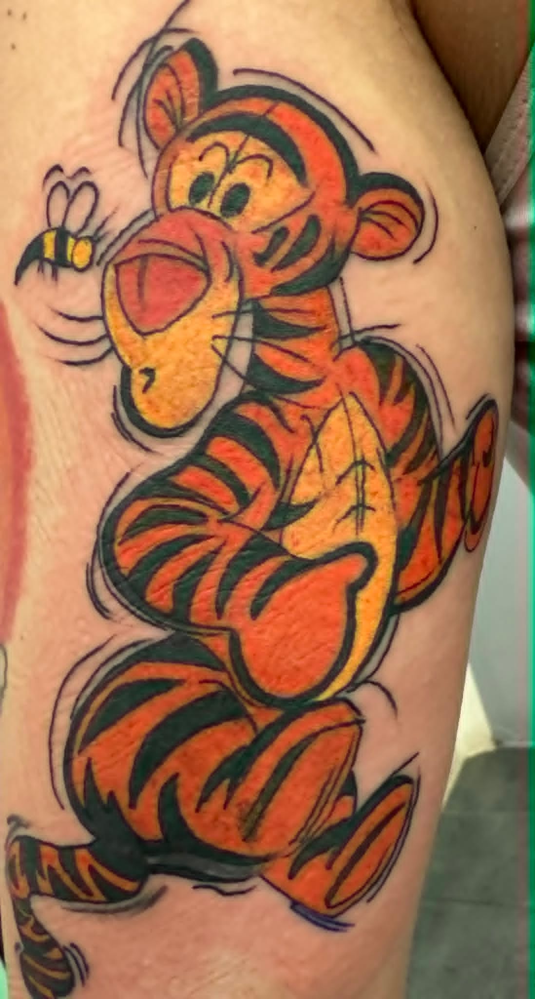 Custom Tigger from Winnie the Pooh chasing bumblebee thigh tattoo by John Quinn at Tattoo Zone Newcastle.