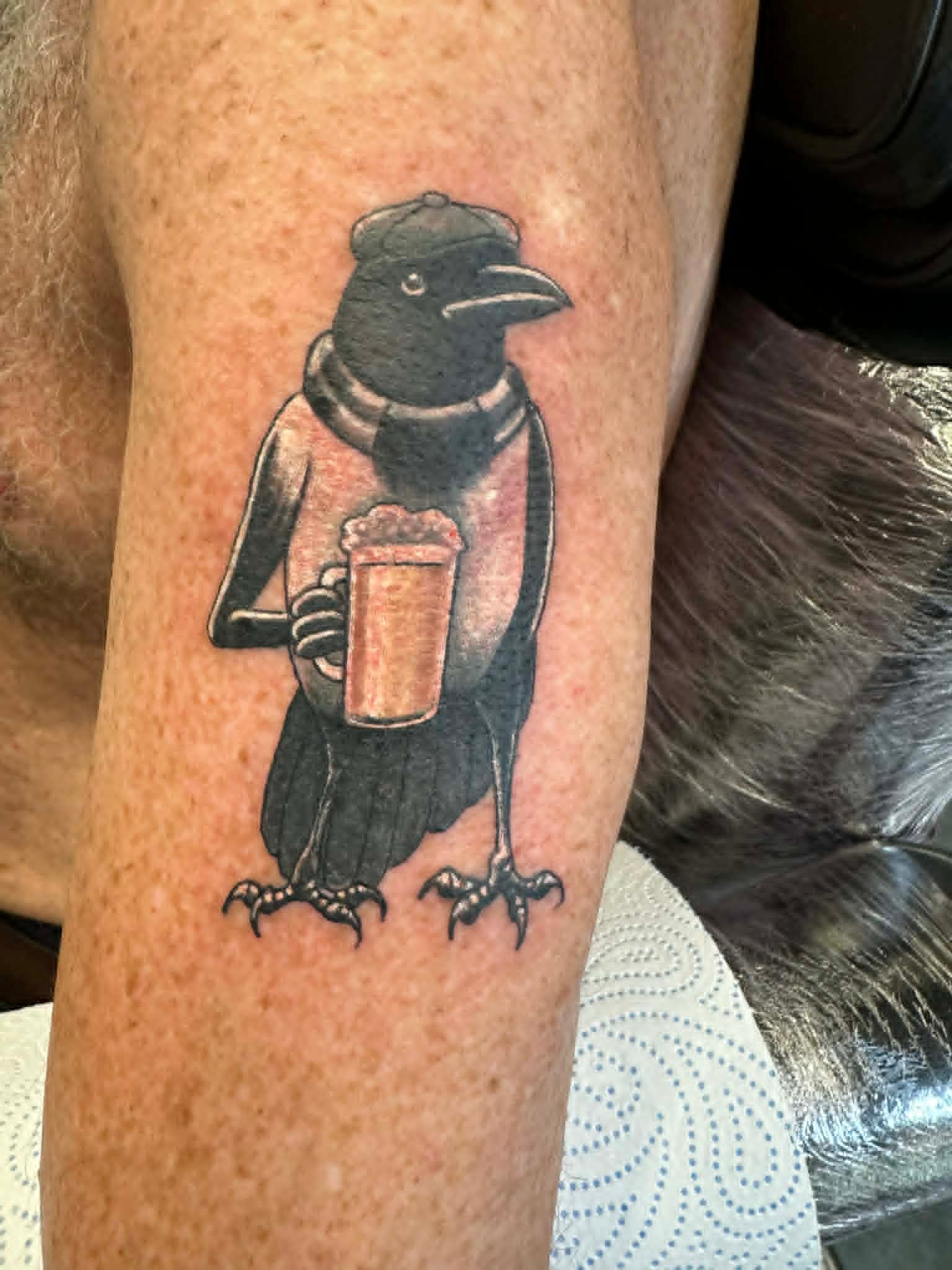 NUFC magpie holding a pint of beer tattoo on the knee by John Quinn at Tattoo Zone, tattoos Newcastle.